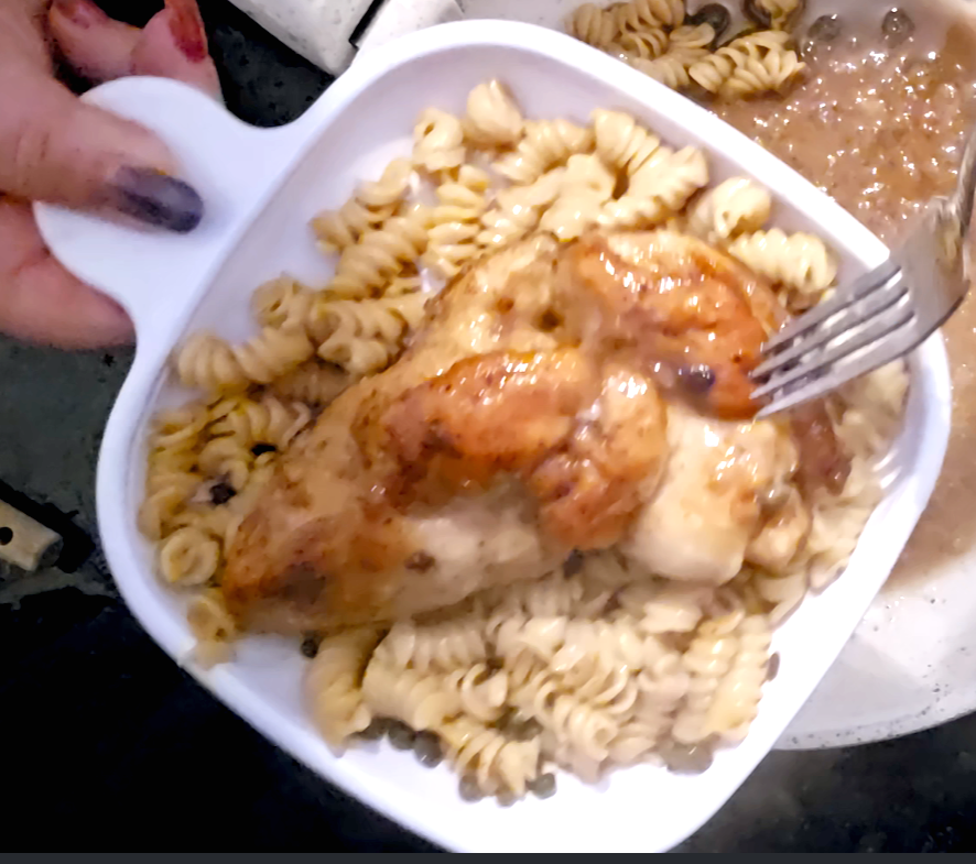 Chicken Piccata made from chicken, lemon and white wine atop pasta