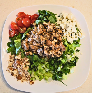 Lettuce greens, cherry tomatoes, blue cheese crumbles, green onions and walnuts (in this case almonds) come together with marinated mushrooms in this divine salad.